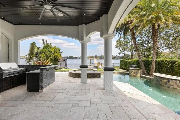a view of a patio with swimming pool table and chairs