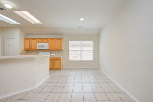 a view of a kitchen with a stove cabinets and a window
