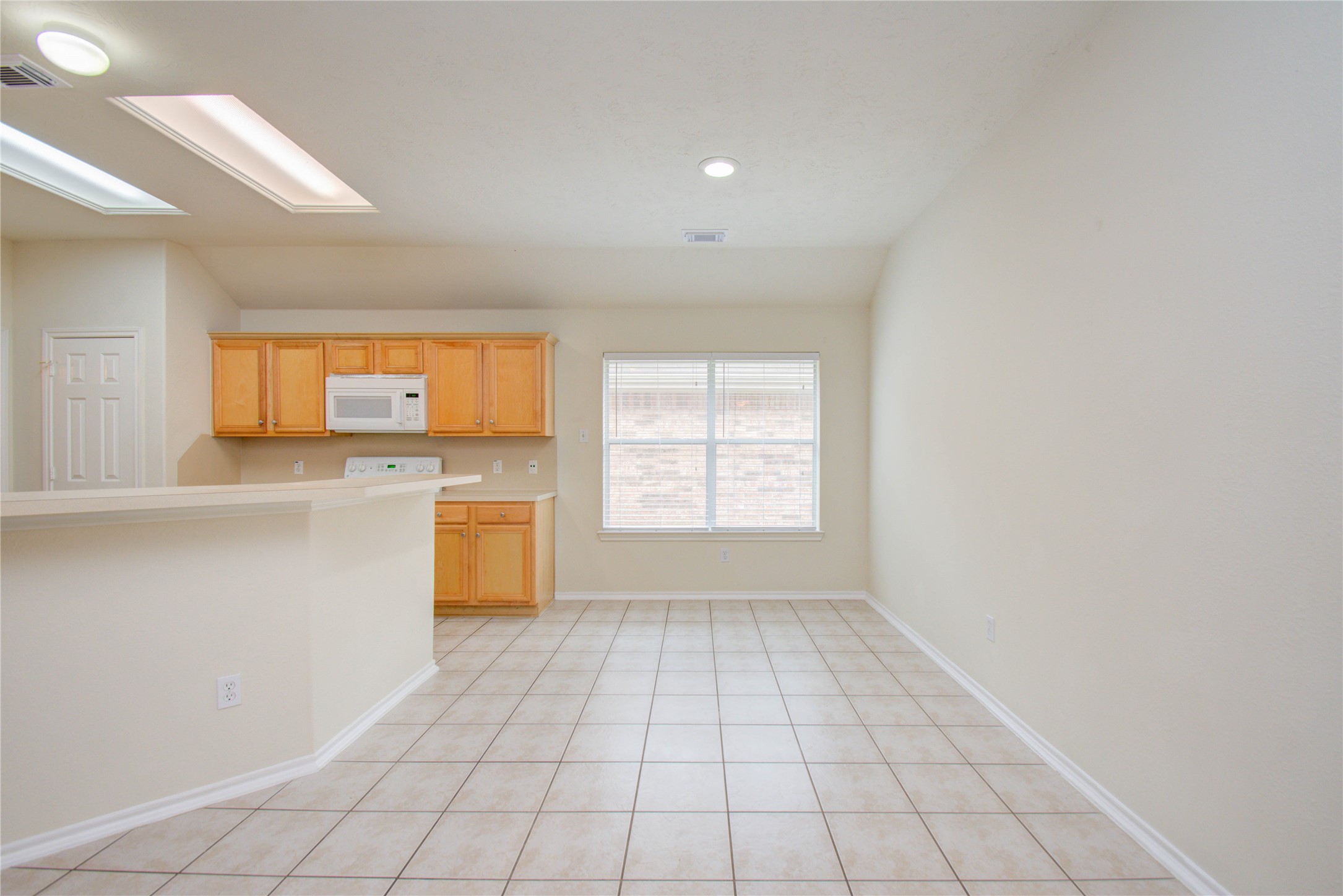 5715 Afton Ridge Lane Houston, TX 77084 - Photo 11 of 37 a view of a kitchen with a stove cabinets and a window