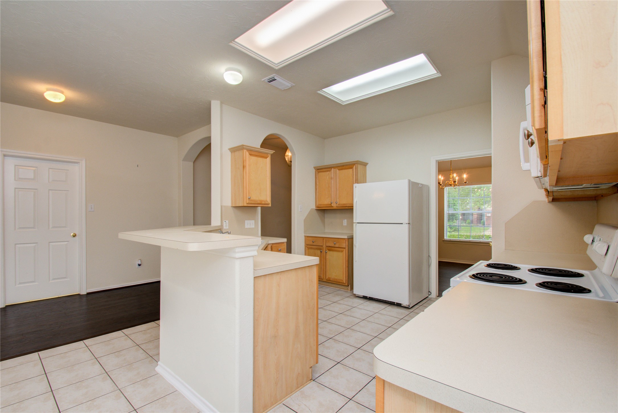 5715 Afton Ridge Lane Houston, TX 77084 - Photo 13 of 37 a kitchen with a refrigerator a stove top oven a counter space and a window