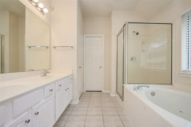 a bathroom with a bathtub and shower