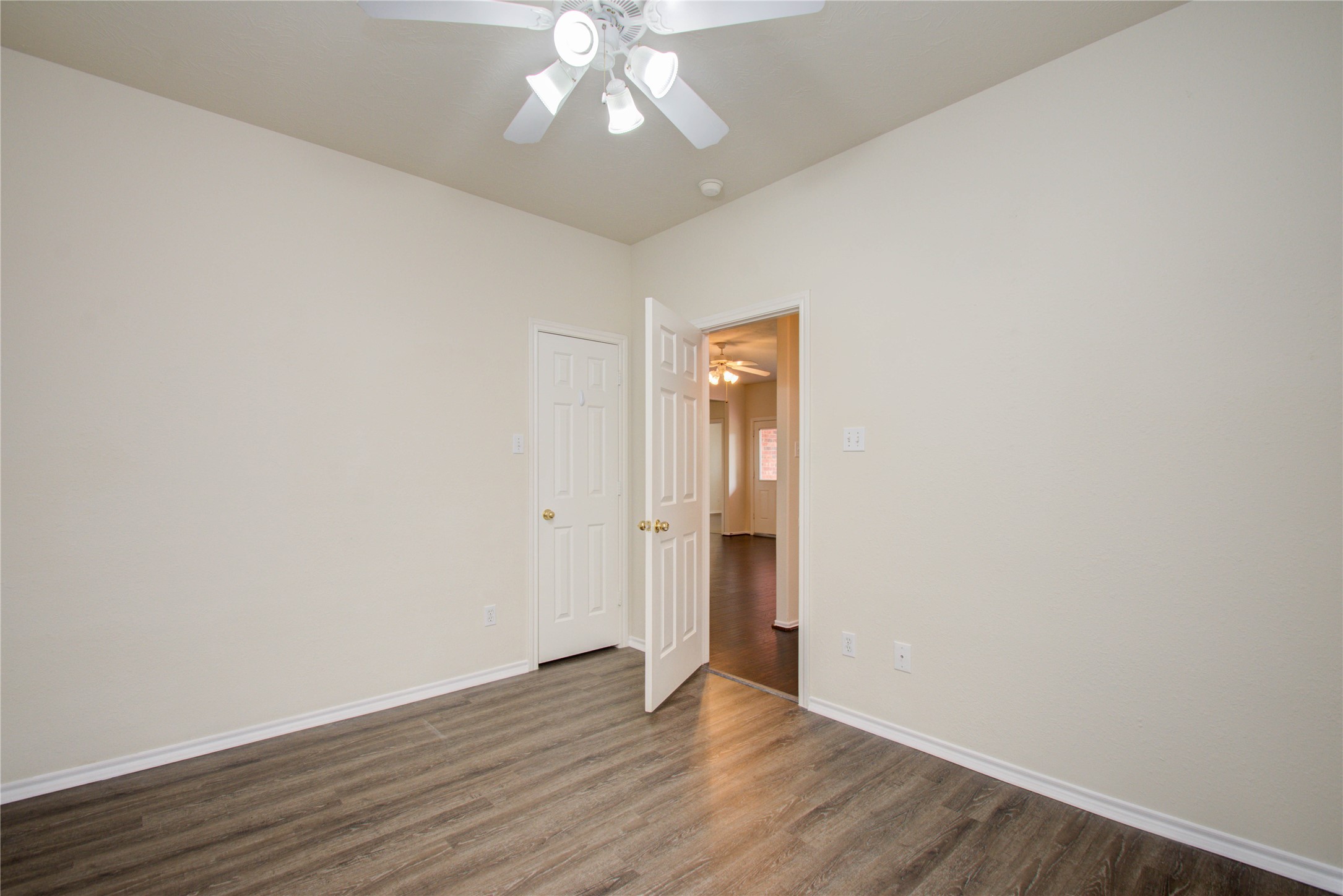 5715 Afton Ridge Lane Houston, TX 77084 - Photo 28 of 37 an empty room with wooden floor and windows