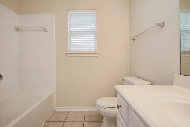 an empty room with a window and wooden floor