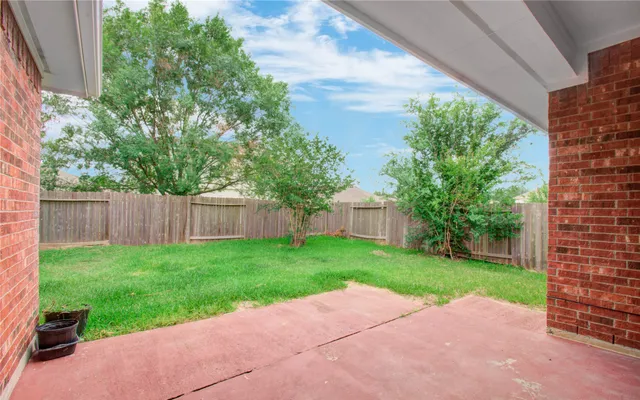 a backyard of a house with table and chairs