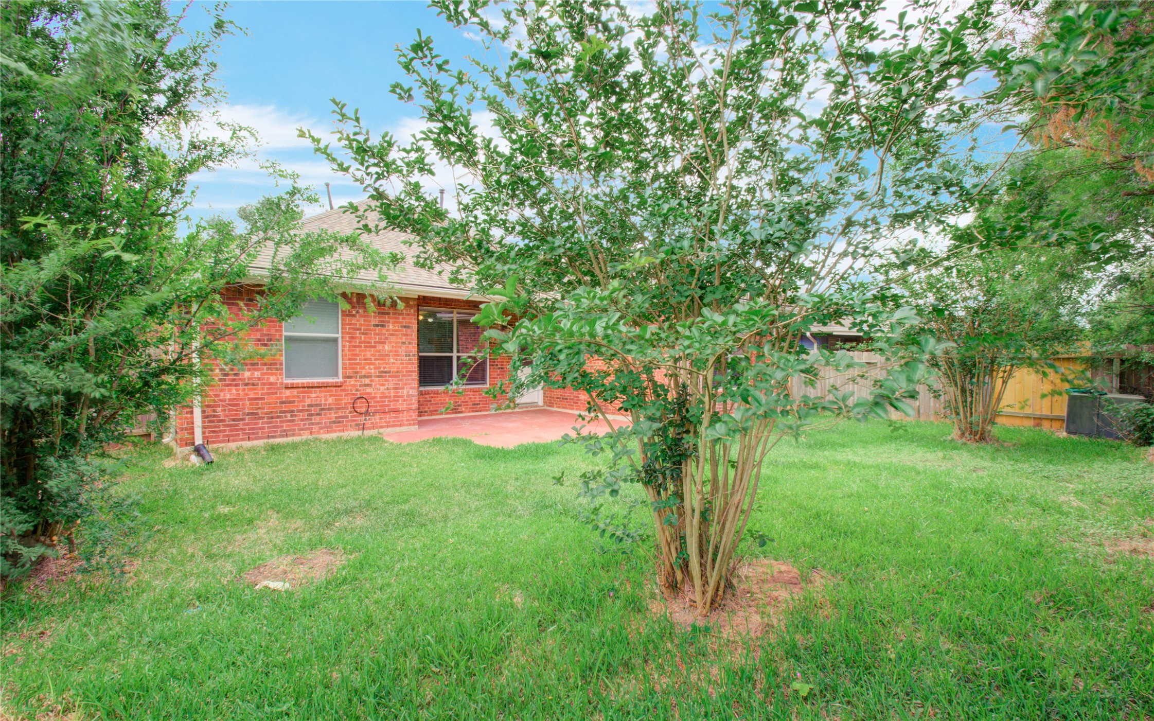 5715 Afton Ridge Lane Houston, TX 77084 - Photo 33 of 37 a backyard of a house with table and chairs