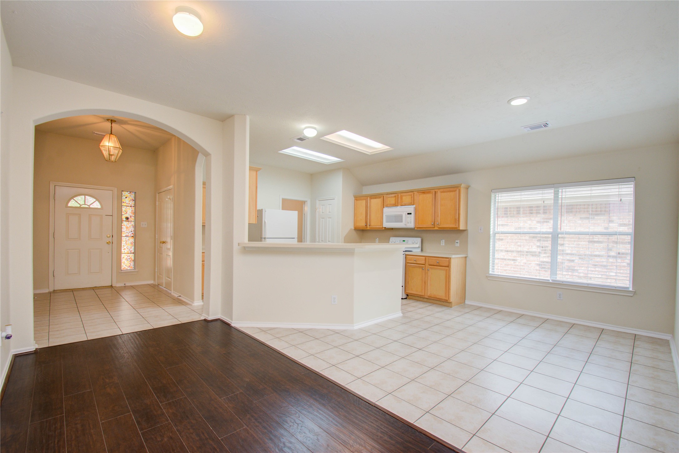 5715 Afton Ridge Lane Houston, TX 77084 - Photo 10 of 37 an empty room with wooden floor and windows