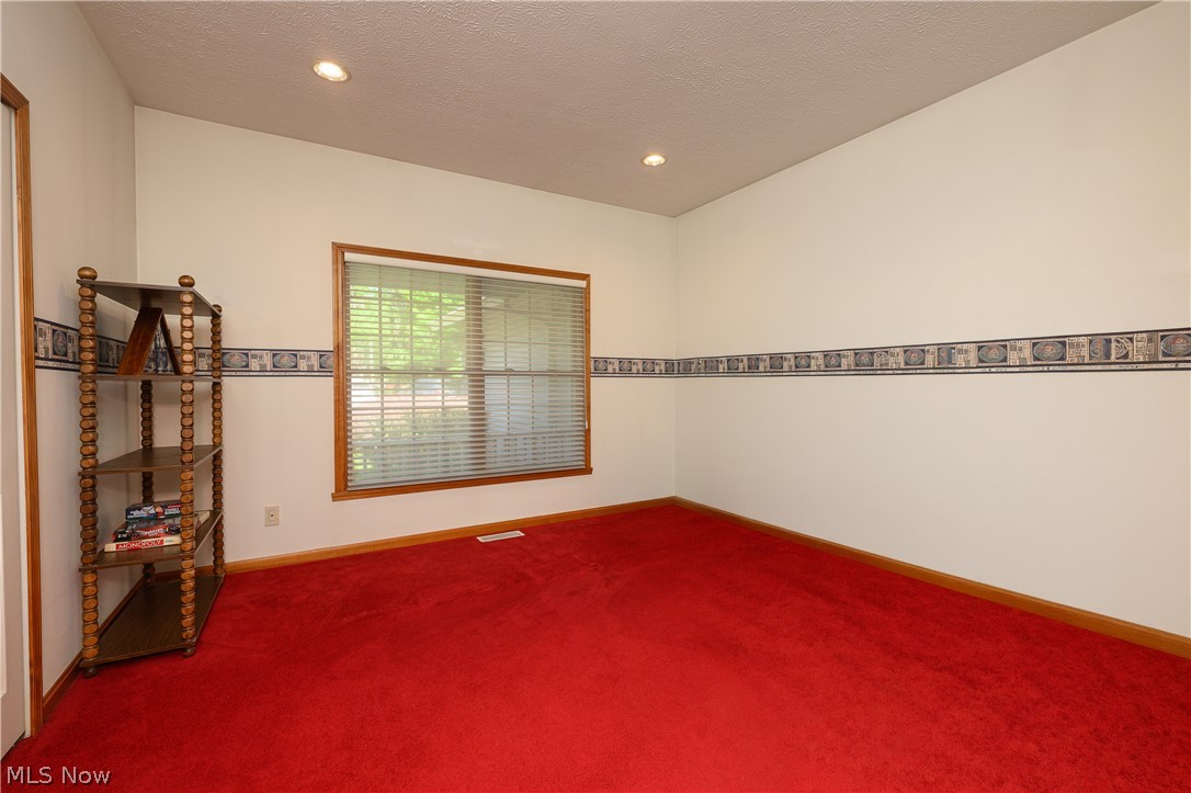 8745 Broadview Road Broadview Heights, OH 44147 - Photo 19 of 49 Bright room with red carpeting, white walls, and a window with wood trim