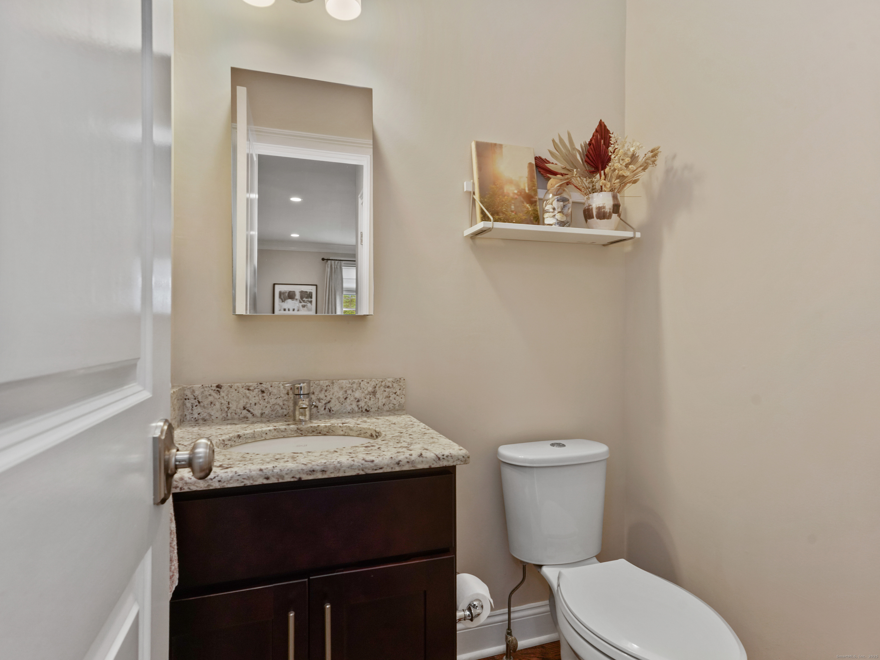91 West Broad Street, Unit 11 Stamford, CT 06902 - Photo 13 of 26 a bathroom with a toilet a sink and mirror