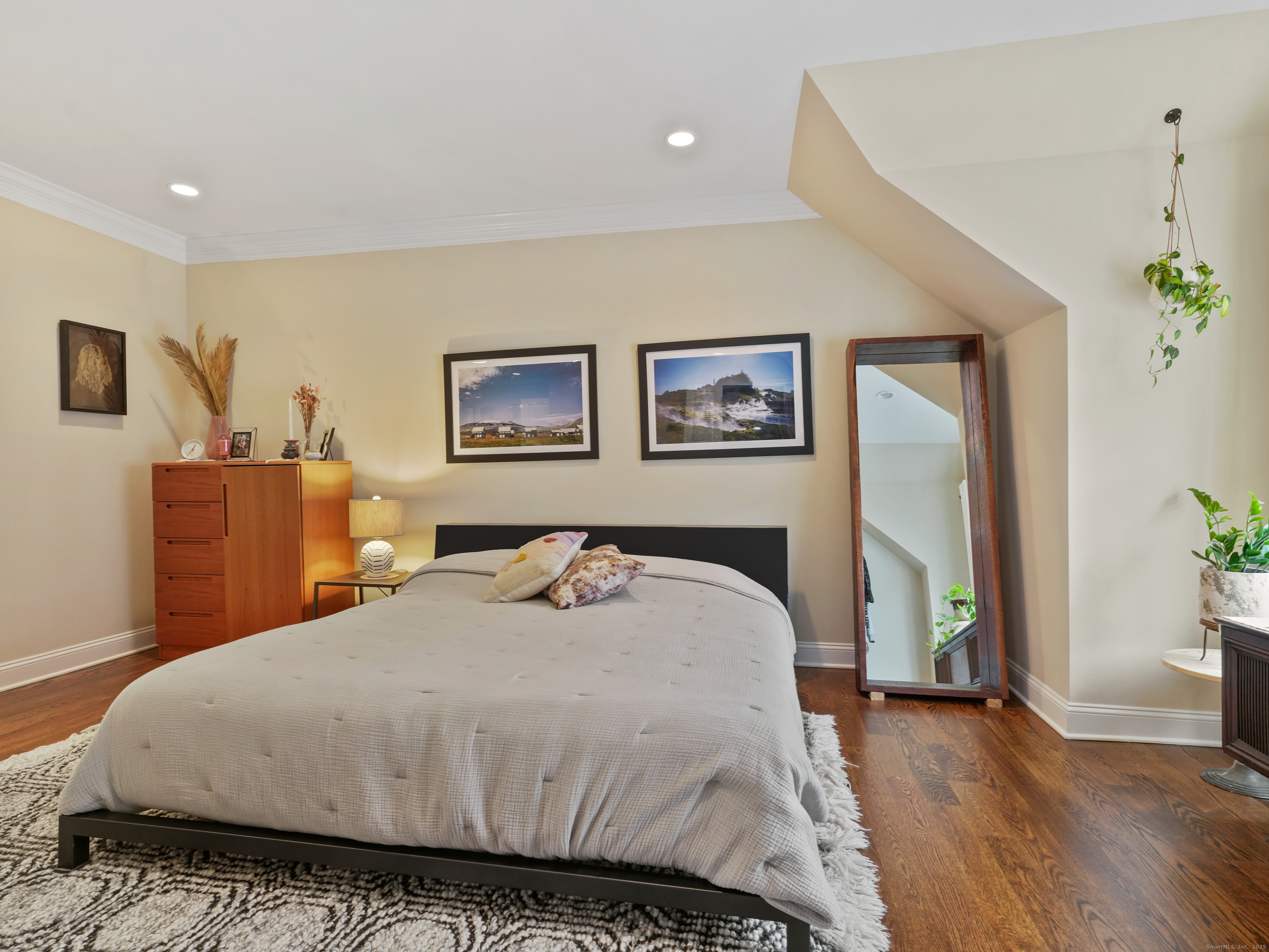 91 West Broad Street, Unit 11 Stamford, CT 06902 - Photo 22 of 26 a bedroom with a large bed and a wooden floor