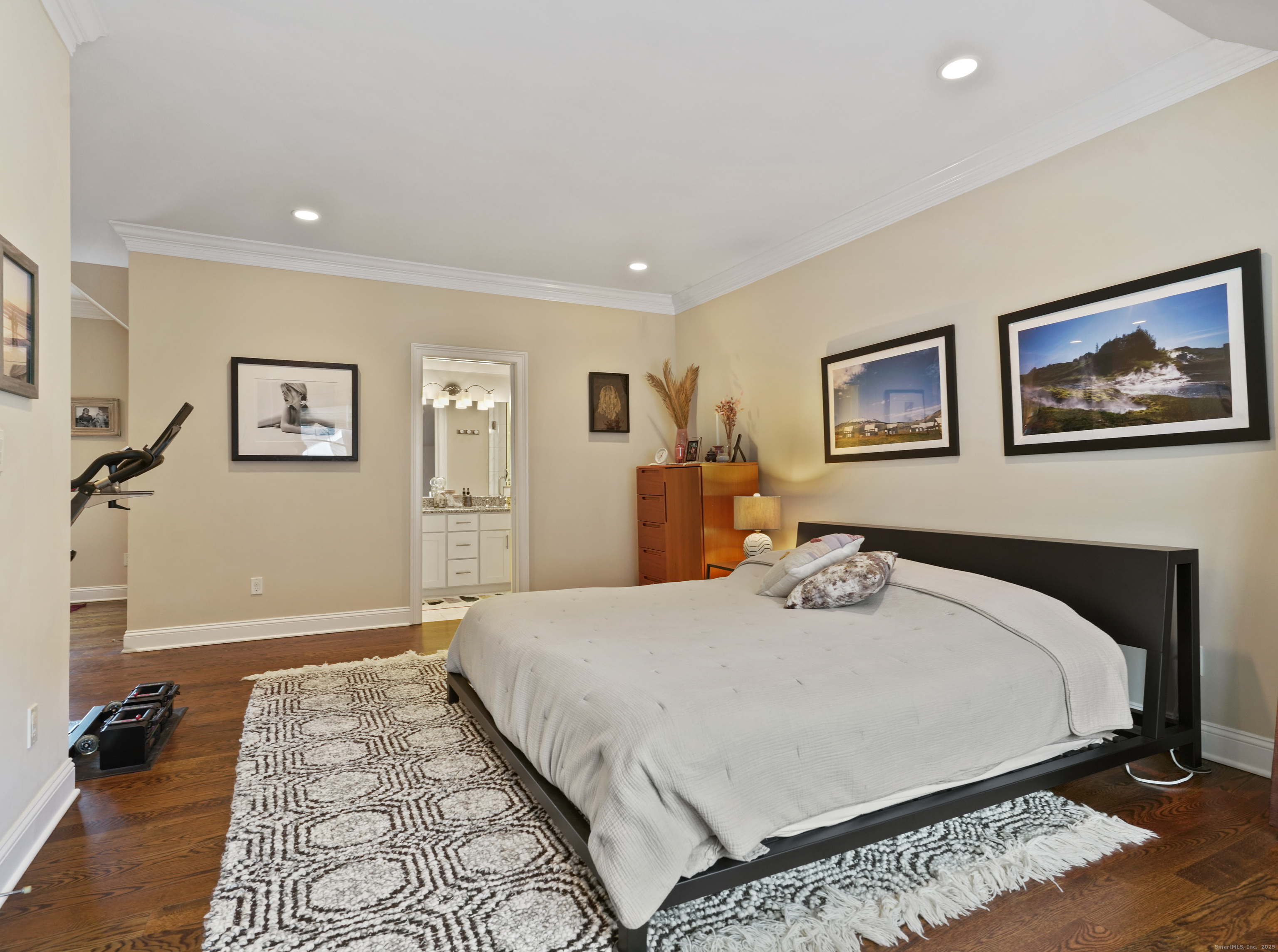 91 West Broad Street, Unit 11 Stamford, CT 06902 - Photo 23 of 26 a bed sitting in a bedroom and a large mirror with wooden floor