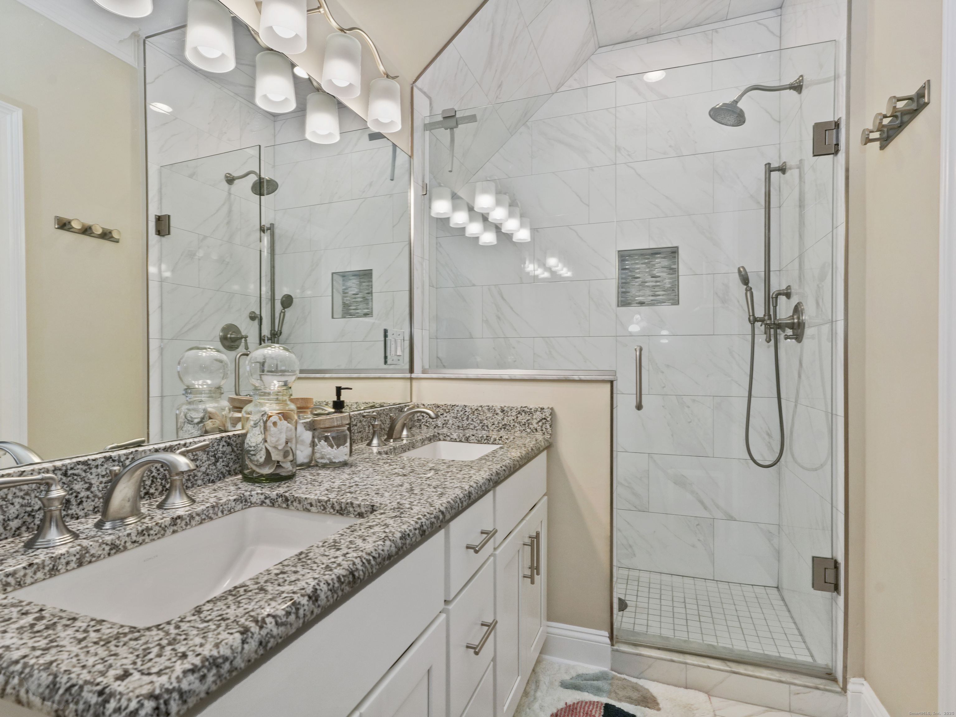 91 West Broad Street, Unit 11 Stamford, CT 06902 - Photo 24 of 26 a bathroom with a granite countertop shower sink and mirror
