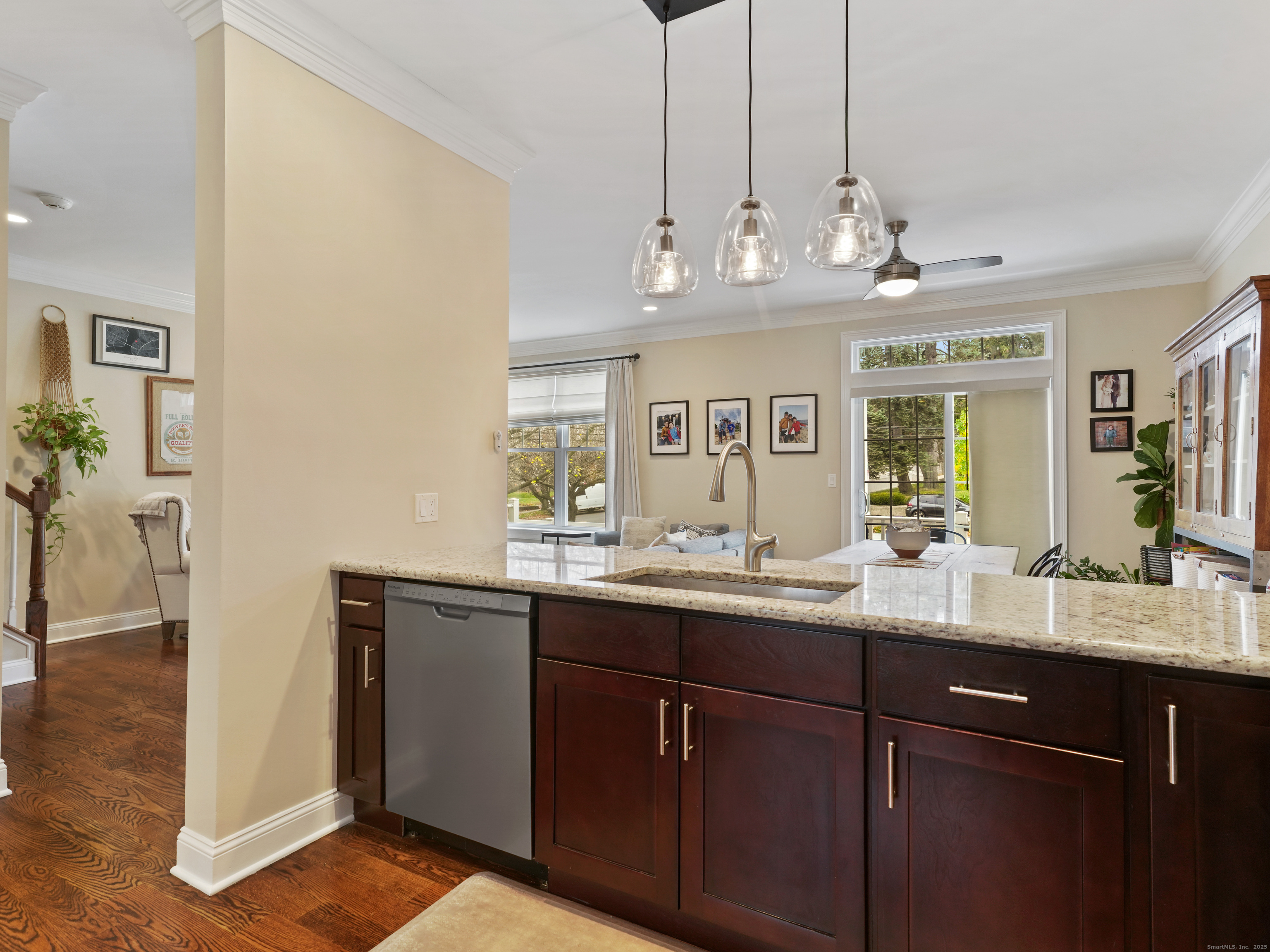 91 West Broad Street, Unit 11 Stamford, CT 06902 - Photo 4 of 26 a kitchen with kitchen island granite countertop stainless steel appliances a sink and cabinets