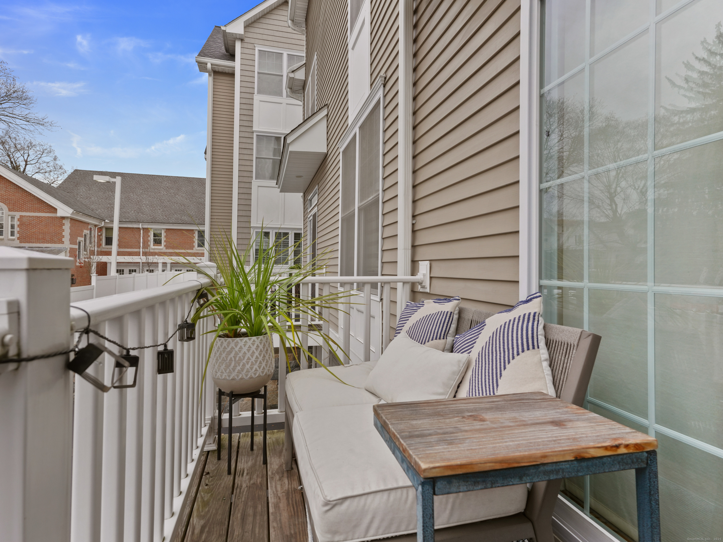 91 West Broad Street, Unit 11 Stamford, CT 06902 - Photo 8 of 26 a view of a balcony with table and chairs