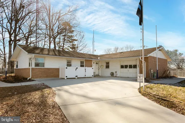 a view of a house with a yard covered in snow