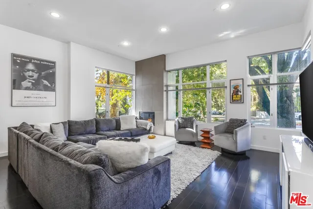 a living room with furniture and large windows
