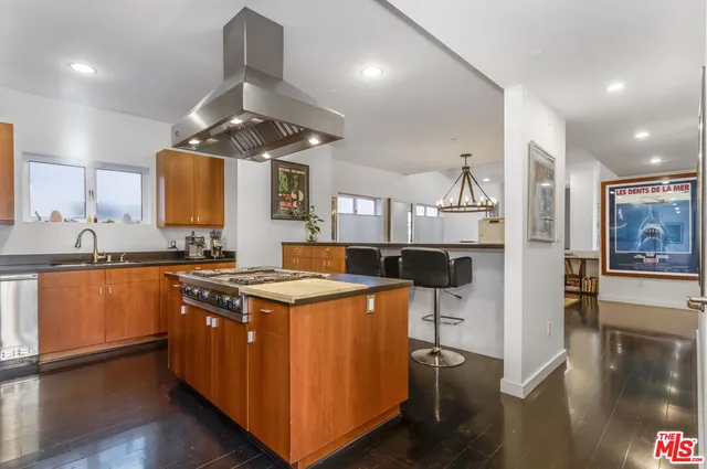 a kitchen with stainless steel appliances granite countertop a stove and a refrigerator