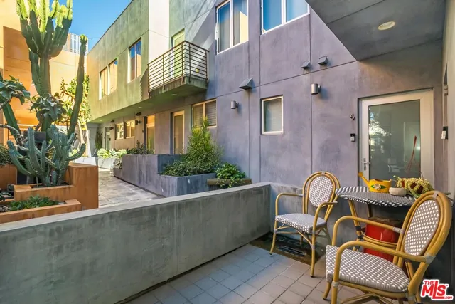 a backyard of a house with table and chairs