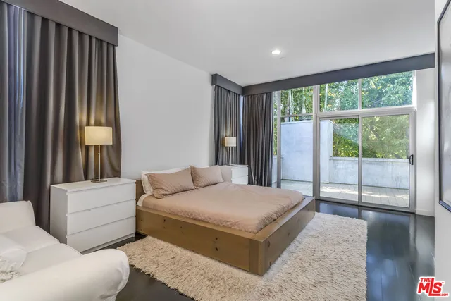 a bedroom with a large bed and a large window