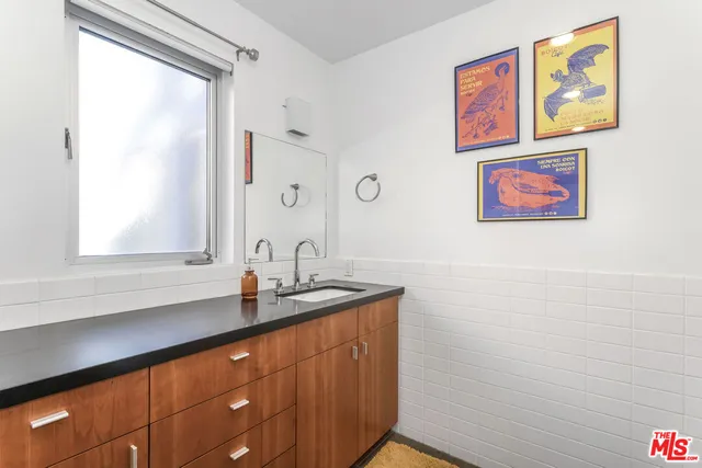 a bathroom with a sink a vanity and a window
