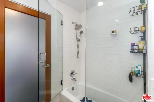 a bathroom with a shower and a bath tub