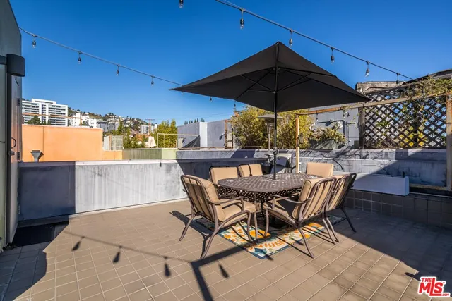 a view of a outdoor sitting area with furniture and umbrella