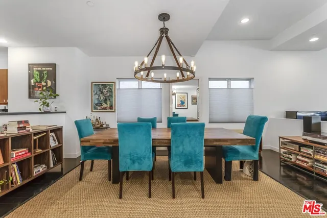 a view of a livingroom and a dining room with furniture window and wooden floor