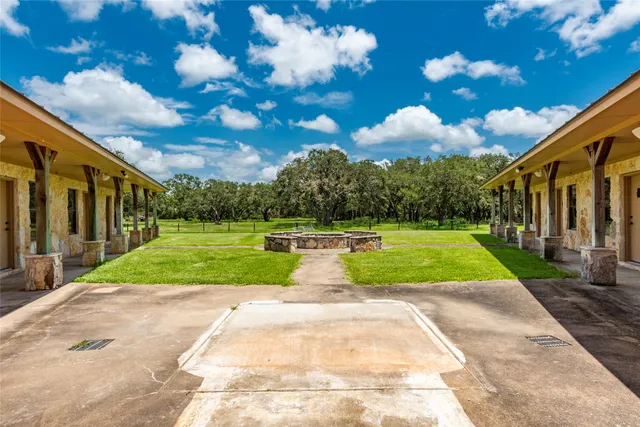 a view of a patio with a table chairs and a backyard