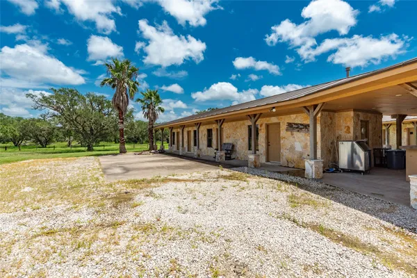 a view of a swimming pool with a table and chairs in patio