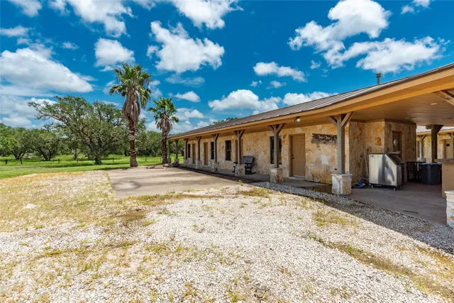 a view of a swimming pool with a table and chairs in patio