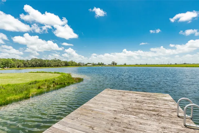 a front view of a house with swimming pool and a yard