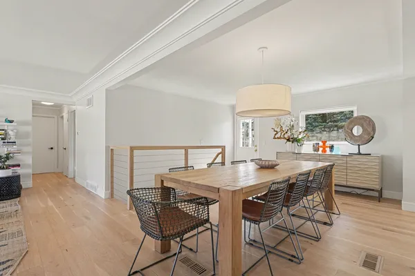 a view of a dining room with furniture and wooden floor