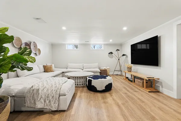 a spacious bedroom with a bed and a flat screen tv