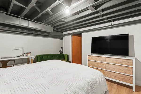 a bedroom with a bed and a flat screen tv