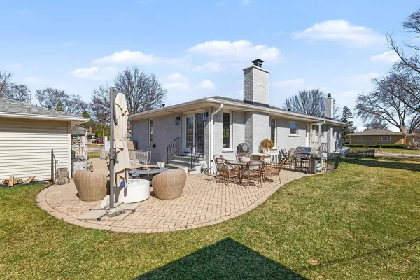 a view of a house with backyard and sitting area