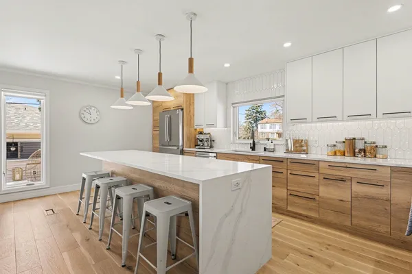 a kitchen with stainless steel appliances kitchen island granite countertop a stove a sink and a refrigerator