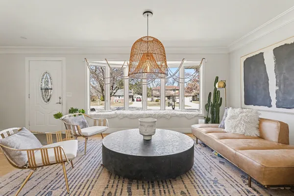 a living room with furniture and a chandelier