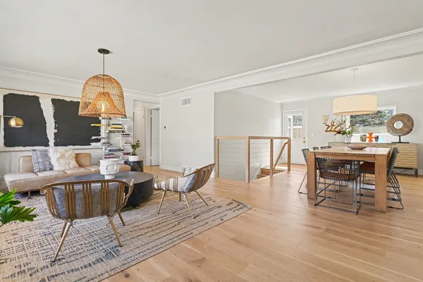 a living room with furniture a rug and a chandelier