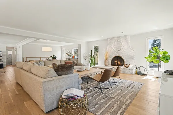 a living room with furniture a fireplace and a table