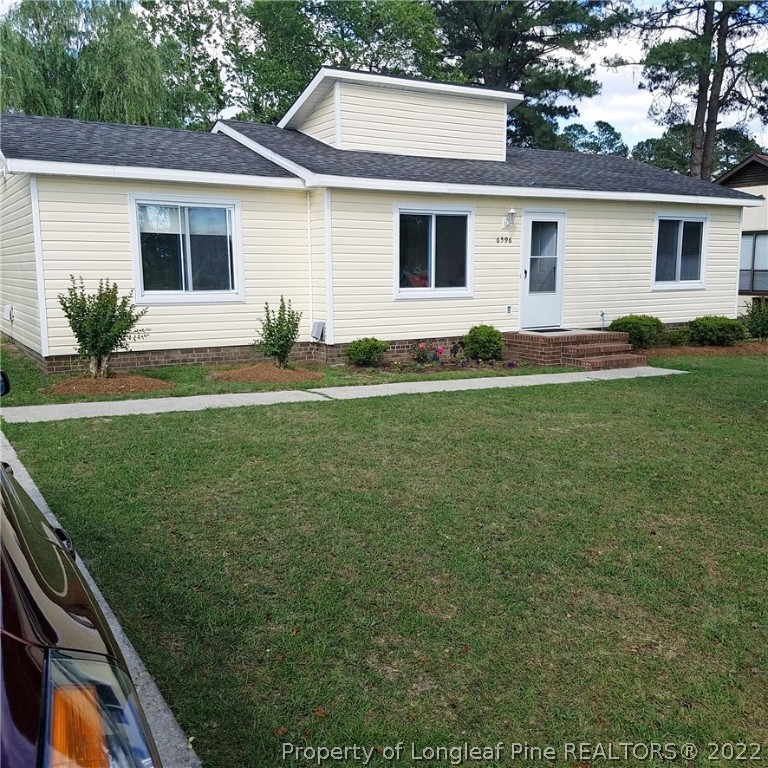 a view of a yard in front of a house with plants