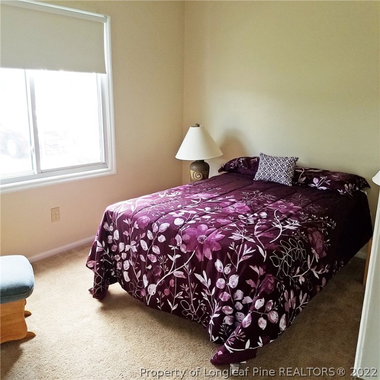 6596 Fisher Road Fayetteville, NC 28304 - Photo 18 of 27 a bedroom with a bed and a window