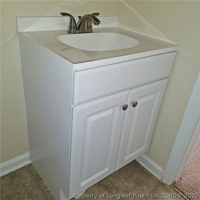 6596 Fisher Road Fayetteville, NC 28304 - Photo 22 of 27 a bathroom with a sink and vanity