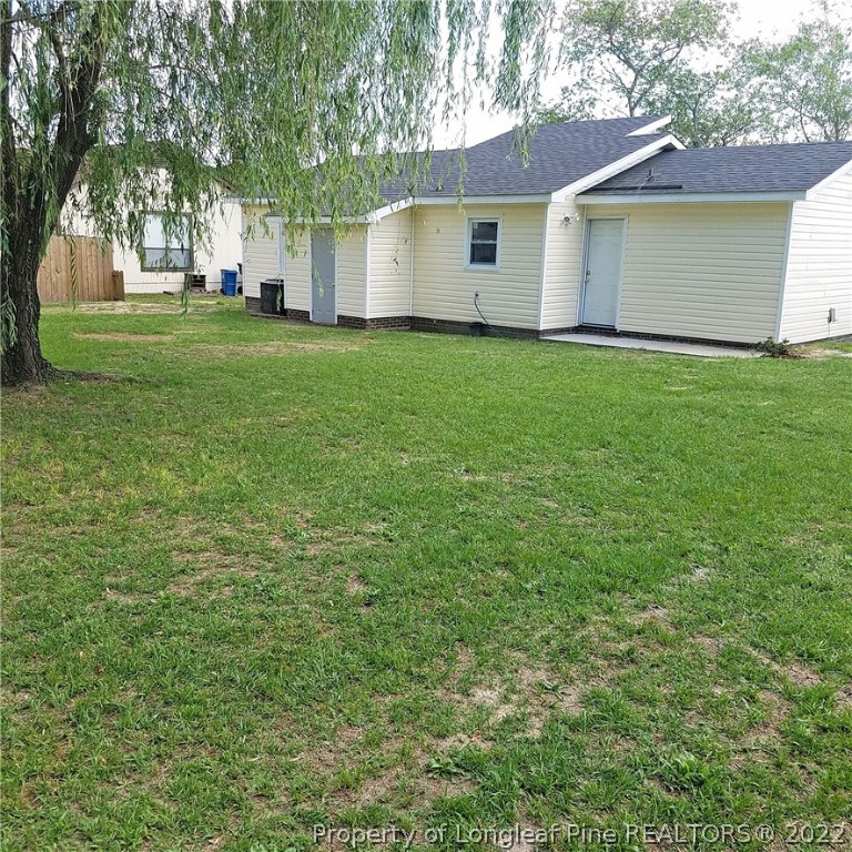6596 Fisher Road Fayetteville, NC 28304 - Photo 24 of 27 a view of a yard in front of a house with large trees