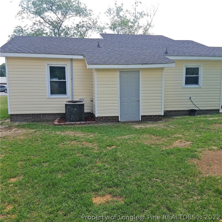 6596 Fisher Road Fayetteville, NC 28304 - Photo 25 of 27 a view of a house with a yard