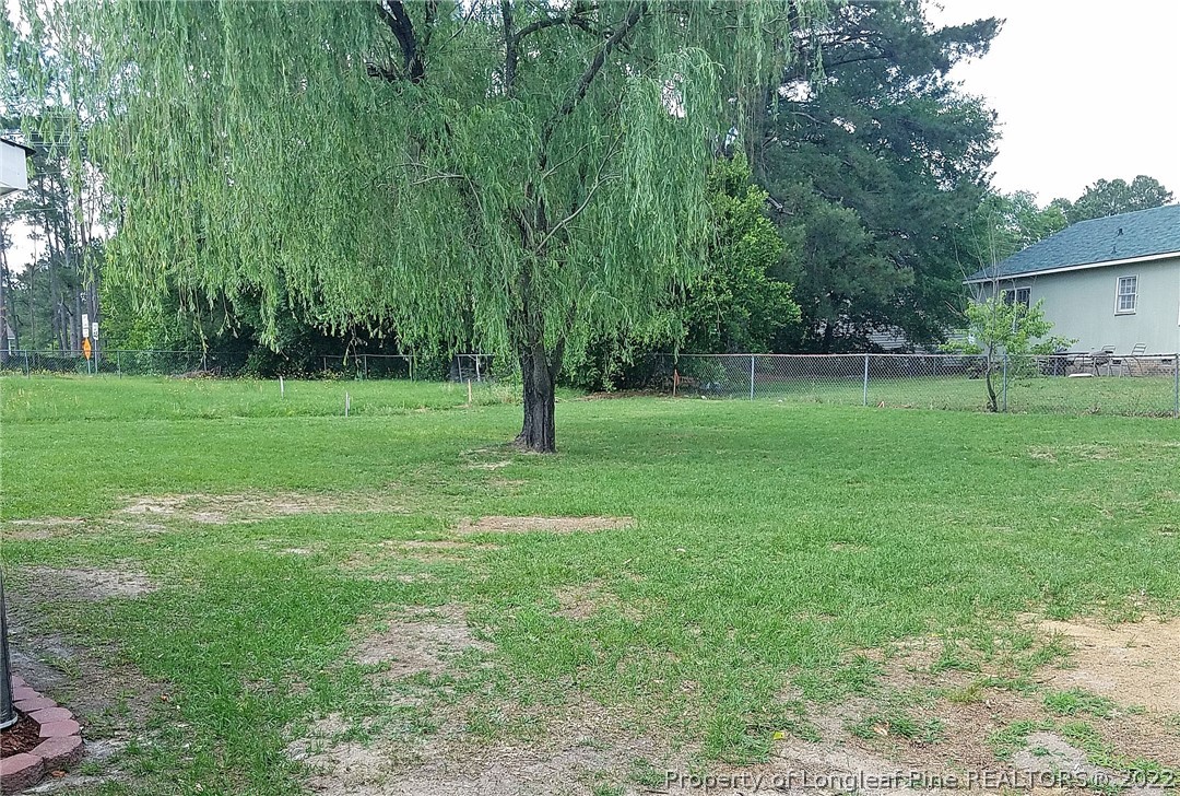 6596 Fisher Road Fayetteville, NC 28304 - Photo 26 of 27 a view of a big yard with a house