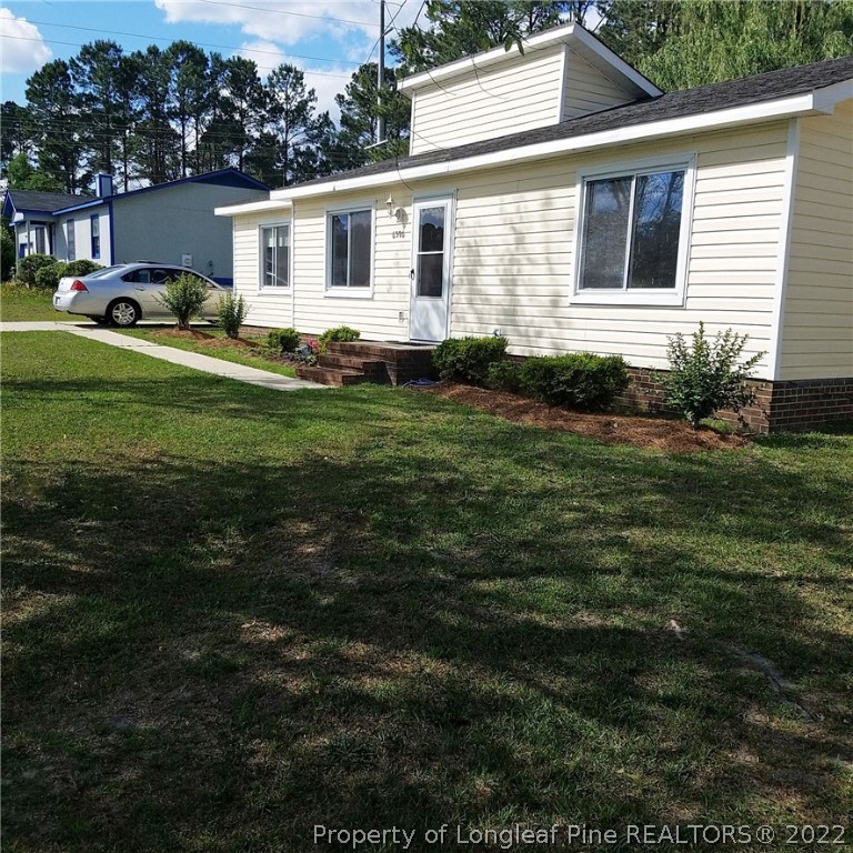 6596 Fisher Road Fayetteville, NC 28304 - Photo 3 of 27 a front view of house with yard and green space