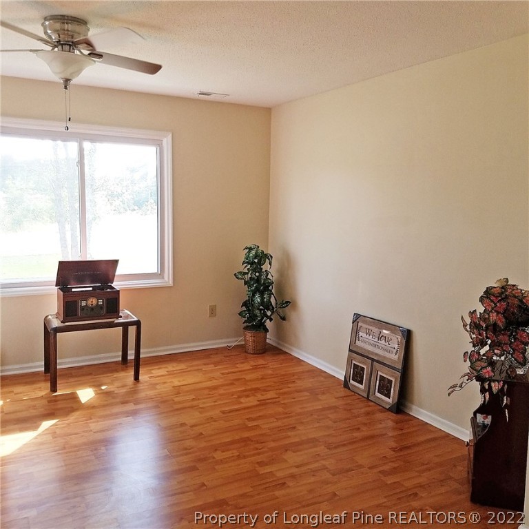 6596 Fisher Road Fayetteville, NC 28304 - Photo 4 of 27 a bedroom with furniture and a window