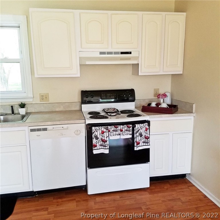 6596 Fisher Road Fayetteville, NC 28304 - Photo 7 of 27 a stove top oven sitting inside of a kitchen