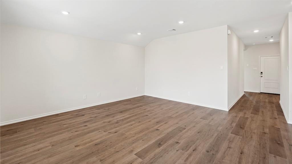 512 Yellow Rose Road Princeton, TX 75407 - Photo 21 of 37 a view of empty room with wooden floor and fan