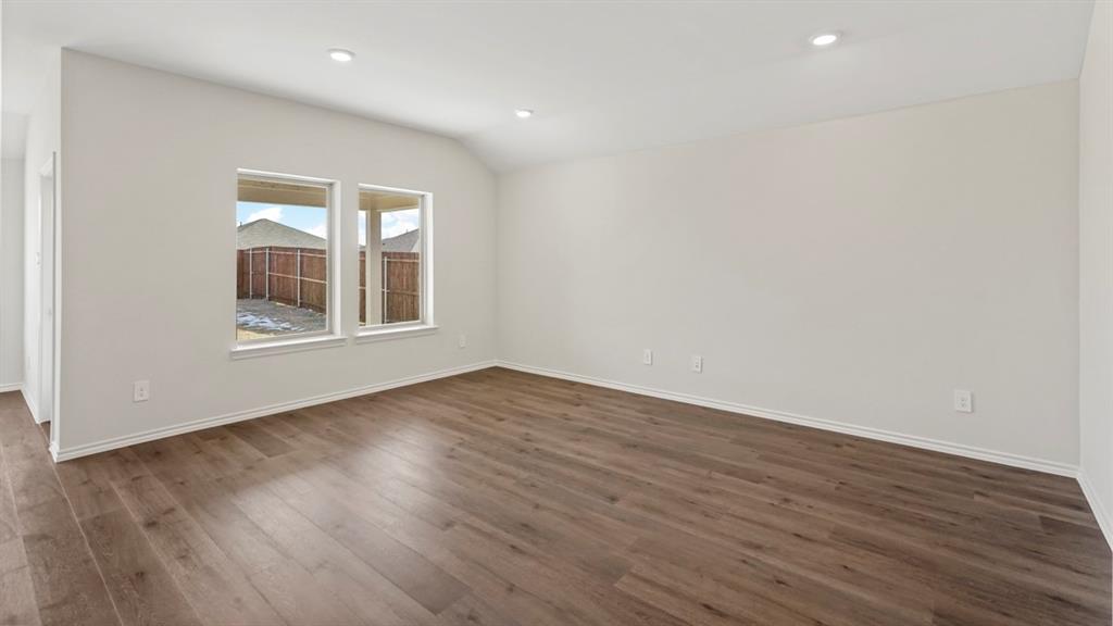 512 Yellow Rose Road Princeton, TX 75407 - Photo 22 of 37 an empty room with wooden floor and windows