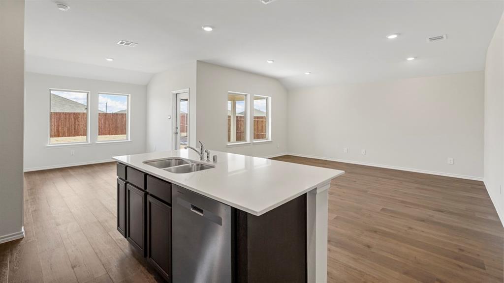 512 Yellow Rose Road Princeton, TX 75407 - Photo 23 of 37 an empty room with wooden floor and windows